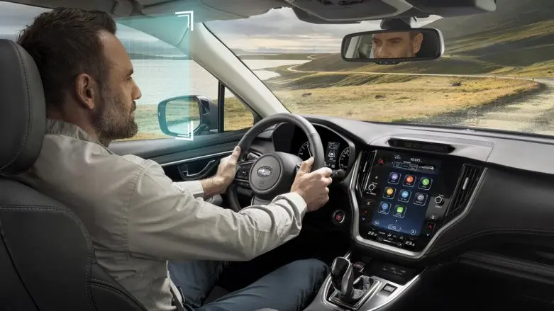 Señor conduciendo auto de Subaru sobre sendero montañoso